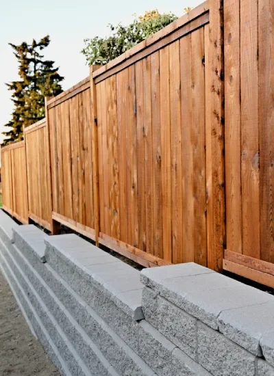 Homeowner receiving retaining wall aftercare advice after project completion