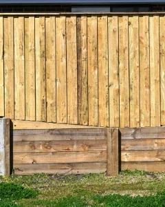 Site levels assessed before planning a retaining wall for a sloped outdoor area